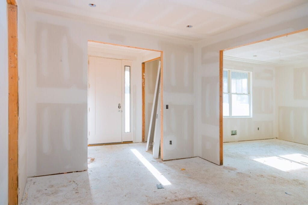 Bright room under renovation with drywall panels.