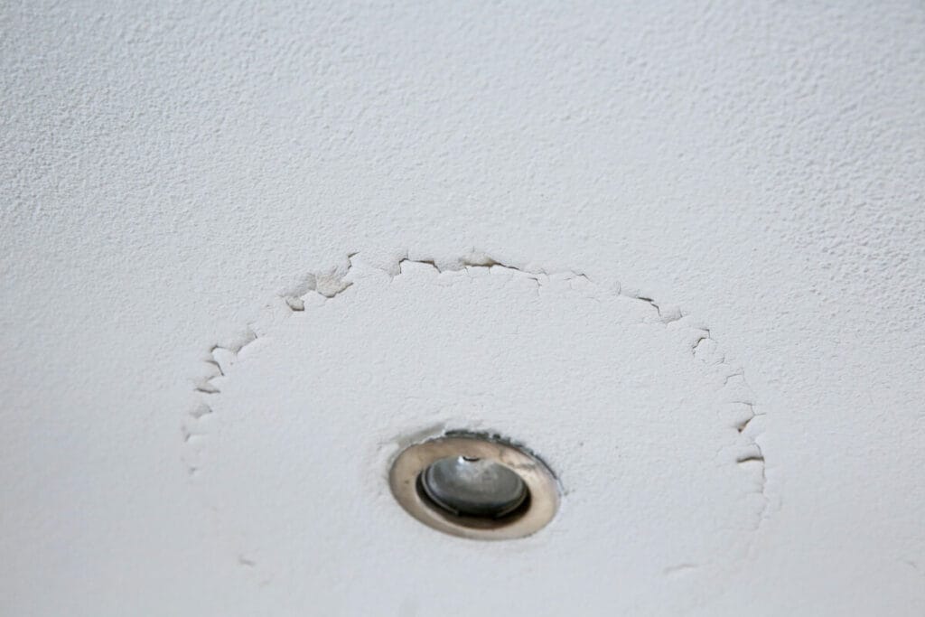 Recessed ceiling light with peeling paint